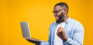 Computer Tricks and Tips Everyone Should Know happy guy with MacBook