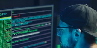 The Essential Guide to Domain Checkers: Why They’re Important and How to Use Them Domain checker man checking computer code on monitor