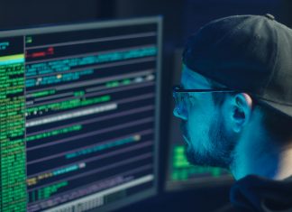 The Essential Guide to Domain Checkers: Why They’re Important and How to Use Them Domain checker man checking computer code on monitor