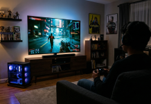The Sofa Sultan’s Guide to PC Gaming on Your TV Man sits on his sofa playing a PC game through his living room TV