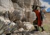 Pearl Abyss Are Showing the Industry What Good Looks Like. The Industry Should Be Taking Notes Crimson Desert Kliff hacks at a mineral on a cliff with a pickaxe