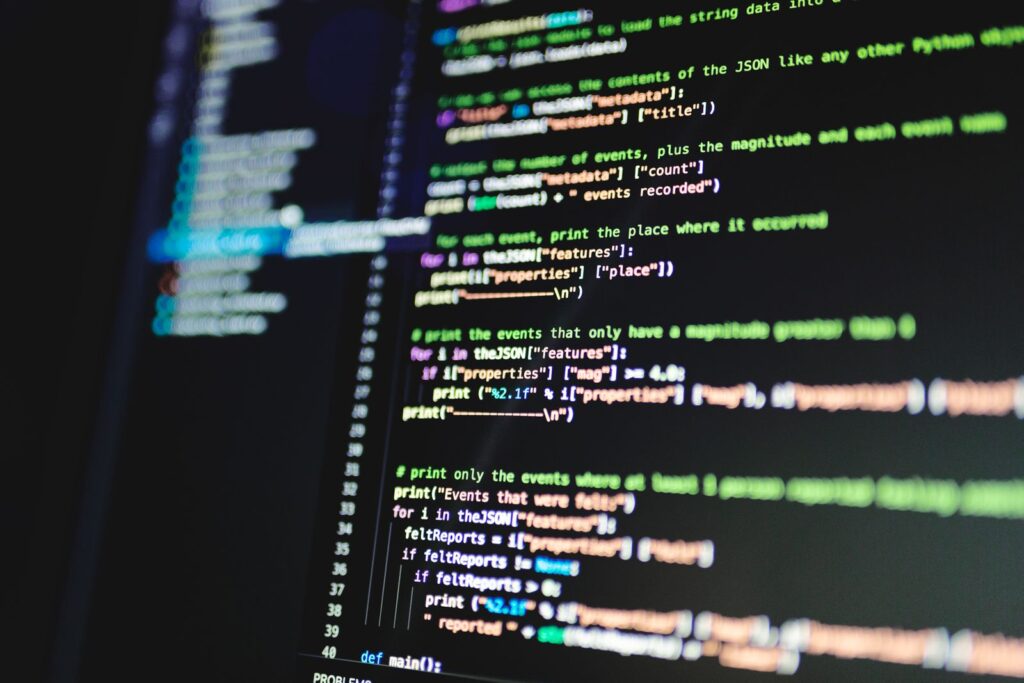 Lines of programming code on a dark computer monitor