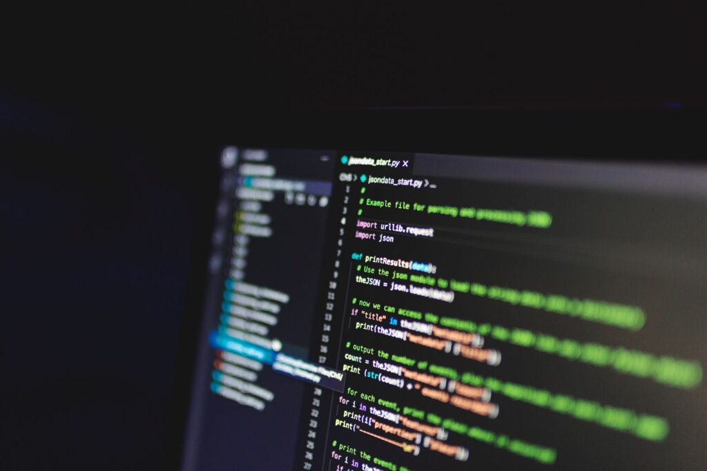 Lines of program code displayed on a monitor in a dark room