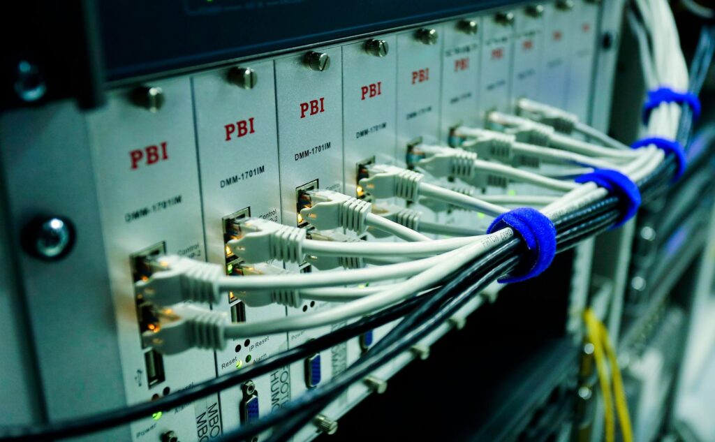 Network cables plugged into a patch panel in a data centre rack