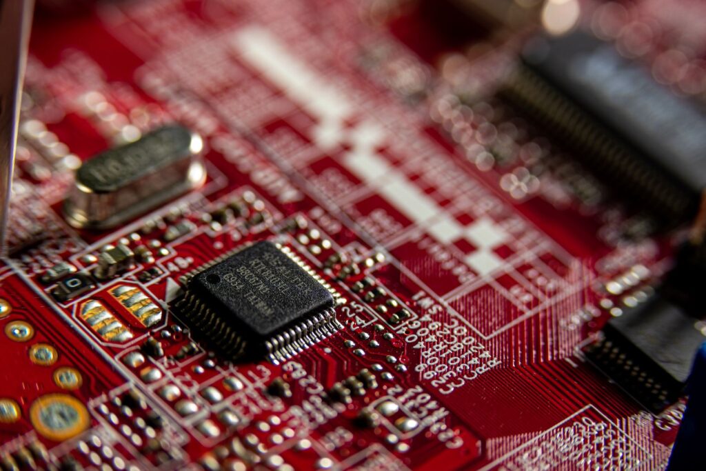 Macro shot of a microchip on a red circuit board