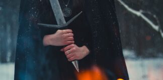 Dark Messiah Community Edition gets Steam page with co-op and restored cut content Cloaked figure gripping a sword beside a fire in the snow